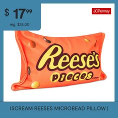 an orange pillow with reese's pieces on it and the price is $ 17 99