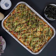 a casserole dish with broccoli and other toppings on a table