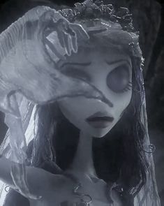 the corpse bride is holding her head with one hand