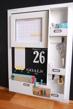 a white cabinet with magnets on the door and calendar attached to it's sides