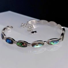 Sterling silver Abalone Shell bracelet, adjustable length from 16.5cm to 22cm.  Please contact me if you need a different length which I will be able to do it within 2-3 days. 💎Natural, handpicked Abalone Shell 💎 Sterling Silver 💎Adjustable - 16.5cm to 22cm Due to the natural colouring of the shell the pattern/colour can vary. We will try our best to select the most beautiful colours available. Rhodium-plated silver is fine sterling silver that is polished and dipped in rhodium. It has a brig Adjustable Oval Sterling Silver Bracelet With Oyster Design, Adjustable Oval Sterling Silver Oyster Bracelet, Adjustable Oblong Jewelry As A Gift, Rectangular Adjustable Sterling Silver Bracelet Gift, Adjustable Rectangular Sterling Silver Bracelet Gift, Abalone Shell Bracelet, Shell Bracelet, Beautiful Colours, Pretty Rings