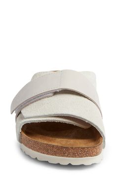 A contoured, cork-textured footbed with a deep heel cup puts support and comfort under every step in a slide sandal topped with a mix of soft leathers. Support: enhances the fit with targeted contouring and cushioning in the footbed Adjustable hook-and-loop strap Contoured, cushioned footbed with arch support Flat sole Leather upper and lining/synthetic sole Made in Germany Suede Slide Footbed Sandals With Leather Footbed, Comfortable Cork Footbed Sandals With Round Toe, Beige Leather Footbed Sandals With Cushioned Sole, Beige Leather Sandals With Cushioned Footbed, Beige Leather Cushioned Footbed Sandals, Comfortable Cork Footbed Sandals, Beige Leather Slides With Leather Footbed, Leather Slide Footbed Sandals With Textured Sole, Comfortable Suede Slide Footbed Sandals