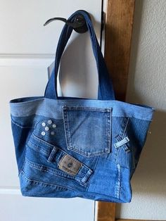 a blue jean purse hanging on a door