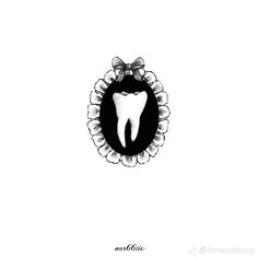 a tooth in the middle of a black and white frame with flowers on it's side