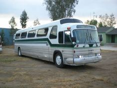 an old bus is parked in the dirt