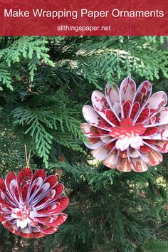 two paper flowers hanging from a tree with text overlay that reads make wrapping paper ornaments