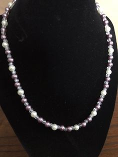 This pearl necklace is a great accessory for any occasion. The materials used for this necklace include purple and white pearl beads with clear glass beads. This necklace features a spring ring clasp with eyelet closure. *If you like this necklace but need it in another size, please contact me, and I will gladly make a necklace for you in the size you need. :) Purple Pearl Single Strand Jewelry, Adjustable Purple Beaded Pearl Necklace, Adjustable Beaded Purple Pearl Necklace, Purple Pearl Single Strand Necklace, Purple Single Strand Pearl Jewelry, Adjustable Purple Pearl Necklace With Round Beads, Handmade Purple Pearl Necklace With Round Beads, Purple Round Beads Pearl Necklace For Gift, Purple Pearl Drop Necklaces