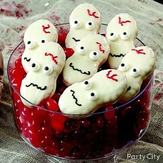 a bowl filled with white frosted cookies covered in sprinkles and eyes