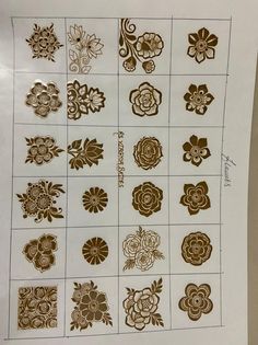 a sheet of paper that has different designs on it, including flowers and leaves in gold foil