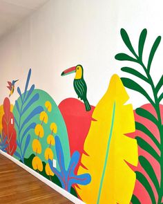 an artistic mural on the wall of a room with birds and flowers painted on it