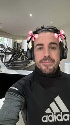 a man with headphones on sitting at a gym