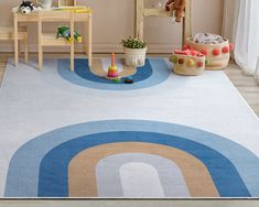 a child's play room with toys and rugs in pastel colors on the floor