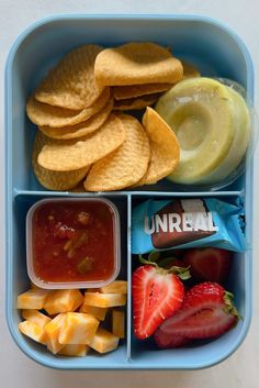 a blue lunch box filled with fruit, crackers, and other foodstuffs