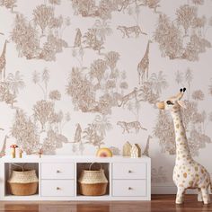 a toy giraffe stands in front of a wallpapered room with baskets and toys