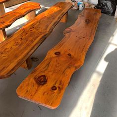 two wooden benches sitting next to each other