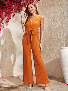 This beautiful and elegant Collar Pleated Belted Shirt Jumpsuit is perfect for any occasion. The shawl collar and pleated detailing give a classic look, while the belted and wrapped design adds a touch of modern sophistication. The long length and high waistline give it a flattering fit, and the regular fit is comfortable and easy to wear. This orange and blue dress is sure to be a wardrobe staple and will make you look and feel amazing. Specifications: Style: Elegant Pattern Type: Plain Details Shirt Jumpsuit, Comfy Jumpsuits, Stil Elegant, Elegant Pattern, Spring Summer Dress, Sleeveless Jumpsuits, Style Elegant, Shawl Collar, Long Length