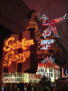 the neon signs are all lit up for people to see