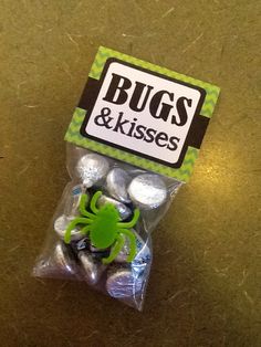 a bag of bugs and kisses candy on a table with a green sticker in it