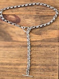 This necklace is a durable, sturdy and long-lasting, hand-polished rolo link chain It consists of a substantial O ring, and a T bar connector, making it a unique piece of jewelry  It can be worn in a variety of different styles by sliding the T bar upwards/downwards to suit any outfit or wear it as it is, the choice is ultimately yours Material Details ❤️Metal - Stainless Steel 316L ❤️Surgical Military Grade Steel ❤️High Gloss Mirror Polished ❤️Platinum Plated Finish ❤️Toggle O Ring 5mm Depth ❤️Rolo Link Chain 6mm Width ❤️T Bar Connector 3mm Depth  ❤️Weight 30g ❤️Hypoallergenic ❤️Lead, Cadmium, Nickel Free ❤️Zero Copper ❤️Anti-Rust ❤️Fade-Resistant ❤️Waterproof Specification  ❤️Customer Support 24/7 Services  ❤️Specialists in Charm Necklaces ❤️Alternative Sizes Available  ❤️Long-Term Susta T Bar Necklace, Necklace Layered, Toggle Necklace, Y Necklace, Necklace Chunky, Charm Necklaces, Military Grade, Lariat Necklace, Bar Necklace