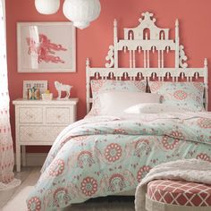 a bed room with a neatly made bed and pink walls