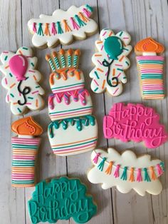 decorated birthday cookies are arranged on a table