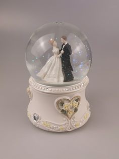 a snow globe with a bride and groom in it