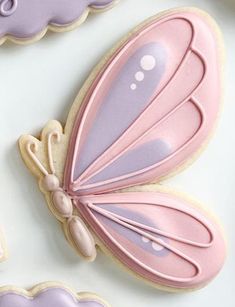 decorated cookies with pink and purple butterflies on them