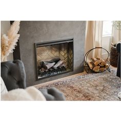 a living room with a fire place and rug