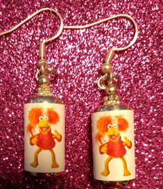 Dance your cares away while wearing these fun Fraggle Rock/ Red Fraggle in a can retro 80s Earrings! An excellent gift for someone who was obsessed with Fraggle Rock muppets! Small in size- less than 1 inch tall and less than 1 inch wide. They are lightweight and great quality. Made with sterling 925 silver hooks.  They come with a gift bag and are made with pure silver hooks. Safe for sensitive ears- lead and nickel free. Retro Sterling Silver Earrings For Gift, Retro Sterling Silver Earrings Gift, Playful Nickel-free Red Earrings, Playful Red Nickel-free Jewelry, Fun Red Adjustable Earrings, Funky Red Handmade Jewelry, Funky Adjustable Jewelry For Gifts, Funky Adjustable Jewelry For Gift, Quirky Red Jewelry For Gifts