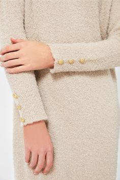 As cozy as a sweater as it is a chic dress, Nelle will take you from clocking hours at the office to dinner followed by a show with a quick switch of accessories. Crafted from a creamy tan boucle knit fabric with gold buttons detailed on the cuffs, this minimalistic maxi is ready to be dressed up or down. With a relaxed fit that is as comfortable as it is flattering, we are wearing this with heels and gold jewelry for a timeless look. Crew neckline Long sleeves Gold buttons on cuffs Relaxed fit Chic Neutral Sweater Dress For Winter, Cream Long Sleeve Sweater Dress For Work, Chic Long Sleeve Neutral Sweater Dress, Beige Textured Knit Long Sleeve Sweater Dress, Beige Long Sleeve Textured Knit Sweater Dress, Chic Cream Long Sleeve Sweater Dress, Elegant Neutral Sweater Dress For Fall, Chic Beige Sweater Dress For Fall, Elegant Beige Sweater Dress For Winter