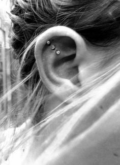 an ear piercing is shown in this black and white photo, with the caption below it