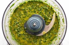 a food processor filled with pesto sauce