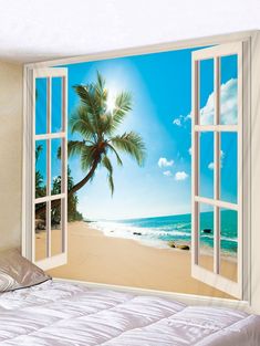 an open window with a view of the beach and palm tree