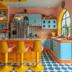 a kitchen with blue cabinets and yellow stools next to a counter top that has four chairs on it