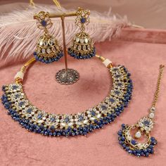 "Antique gold necklace set with glass mirror stones and tiny colourful beads. Necklaces adjustable to fit. Includes lightweight  2 inch length Earrings and inch elegant tikka *Model image for size and fit reference only\" Ready to ship with gift box." Blue Bollywood Jewelry Sets For Gift, Blue Bollywood Style Jewelry Sets For Gift, Blue Hand Set Necklace For Diwali, Blue Bollywood Necklace As A Gift, Blue Kundan Necklace For Festive Gift, Blue Jewelry For Diwali Party, Blue Kundan Necklace For Festive Occasions, Blue Kundan Necklace For Festive Occasions As A Gift, Blue Jewelry For Party And Diwali