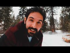 a man with a beard standing in the snow