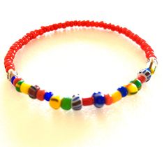 "Colorful African \"Love\" beads mixed with bright red white heart glass beads and Karen Hill Tribe fine silver on a skinny stretch bracelet. These colorful skinny bracelets are trending now in Europe for both men and women! Fun for summer! The 3-4mm multicolored vintage Czech glass beads are handmade in varying sizes and shapes. Originally made to be sent to Africa. The bright red handmade African glass beads are from Ghana and are called \"white heart\" beads because of the pure white painted Red Czech Glass Beaded Bracelets With Colorful Beads, Adjustable Red Czech Glass Beads, Adjustable Red Letter Beads, Red Letter Beads For Gifts, Red Beaded Bracelets With Heart Beads For The Beach, Red Czech Glass Bracelets With Colorful Beads, Adjustable Red Czech Glass Bracelets, Red Czech Glass Beaded Bracelets, Red Heart Beads For Beach