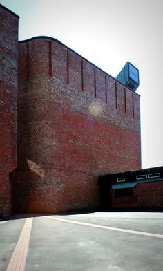 an empty parking lot in front of a brick building