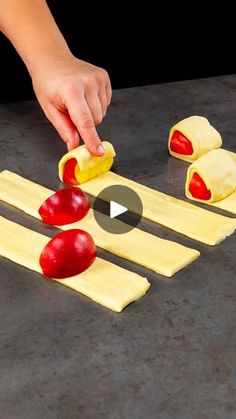 someone is cutting up some food on a table with other foods in the shape of apple slices