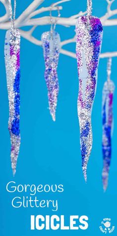 there are some glittery icicles hanging from the clothesline with blue skies in the background