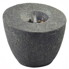 an outdoor fountain made out of concrete with a hole in the center and water running through it