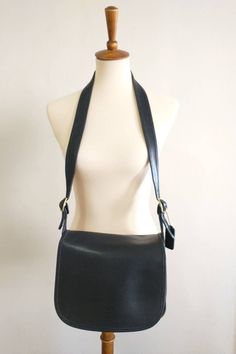 "This beautiful Classic Black Coach shoulder bag has a roomy interior. The inside of the bag has a side pocket with a brass zipper. This does have the Coach creed and although it is faint. There is an extra side pocket which is covered by the flap. This beautiful bag does have the original coach hang tag with brass features. There are scratches on the top flap of the bag and minor piping wear. The straps are adjustable. Over all a really nice bag.  OBO.  Made in Mexico Measurements: Length: 10' Formal Leather Bag With Lined Interior, Elegant Rectangular Shoulder Bag With Lined Interior, Formal Rectangular Bag With Lined Interior, Formal Tote Bag With Lined Interior, Classic Tote Shoulder Bag With Lined Interior, Classic Travel Shoulder Bag With Lined Interior, Elegant Travel Shoulder Bag With Lined Interior, Elegant Shoulder Bag With Lined Interior, Lined Interior Satchel Bag