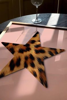 an animal print star on a pink table