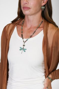 Seasons change, and so do we - the dragonfly has long been a symbol of renewal and change. Hues of green and blues create warmth in this unique handmade collage necklace, finished with a patina dragonfly focal. The perfect addition to your designer jewelry collection. Antique brass (lead- and nickel-free) Czech glass, Turquoise, Freshwater Pearl 20.25-22.25" adjustable length, lobster claw clasp We hand select our natural materials, thus there may be slight variations in color and/or size that w Handmade Bohemian Dragonfly Necklace, Bohemian Handmade Dragonfly Necklace, Collage Necklace, Floyd Va, Designers Jewelry Collection, Handmade Collage, Designer Handmade Jewellery, Dragonfly Necklace, Seasons Change