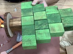 a person is working with wood blocks on a table