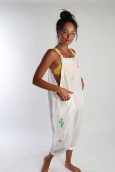 Get groovy by the pool with Romi Basha's Linen Jumpsuit! Hand embroidered and made with 100% linen, this jumpsuit features adjustable straps and front pockets. Perfect for pairing over your favorite swimsuit. Talk about a statement piece!