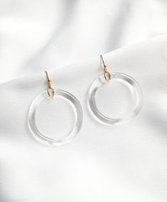 A big circle minimalistic glass earrings. Perfect as a complement to everyday and evening styling. Earrings is made from hard and durable borosilicate glass. Each piece is handmade in the lampworking techinque, which gives it a unique character, therefore each piece can be a little bit different. And this is the biggest value of my products, to make you feel special. All the products are packed safely in the beautiful paper box and will be a perfect gift for yourself or your special one. Perfect for sensitive ears because of their lightness and combination with surgical steel (silver or gold) earrings parts. Glass element diameter: approx. 3,5 cm / borosilicate glass Earwires: surgical steel / silver or gold color Modern Small Hoop Clear Earrings, Modern Clear Earrings For Wedding, Modern Clear Round Earrings, Handmade Clear Round Hoop Earrings, Minimalist Clear Round Earrings, Styling Earrings, Big Circle Earrings, Glass Wedding, Beautiful Paper