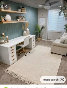 a living room filled with furniture and lots of plants on top of a white rug