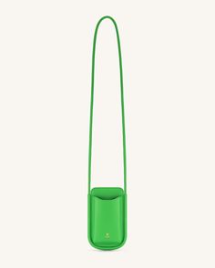 a small green bag with a strap hanging from it's side, on a white background