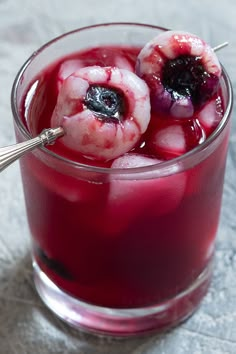 a close up of a drink in a glass with fruit on the rim and garnish